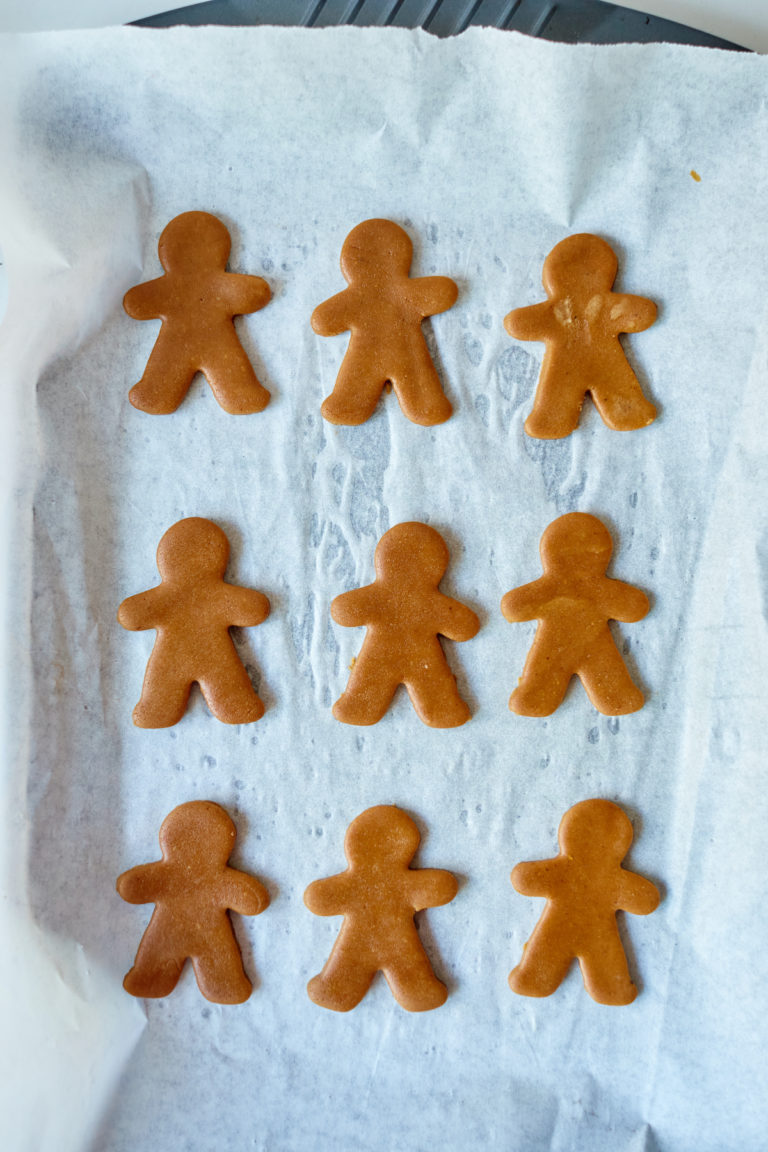 top down view of gingerbread man cookies on a baking tray