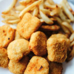 a plate of chicken nuggets and french fries