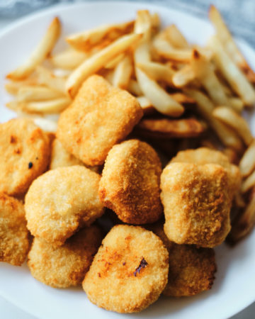 a plate of chicken nuggets and french fries