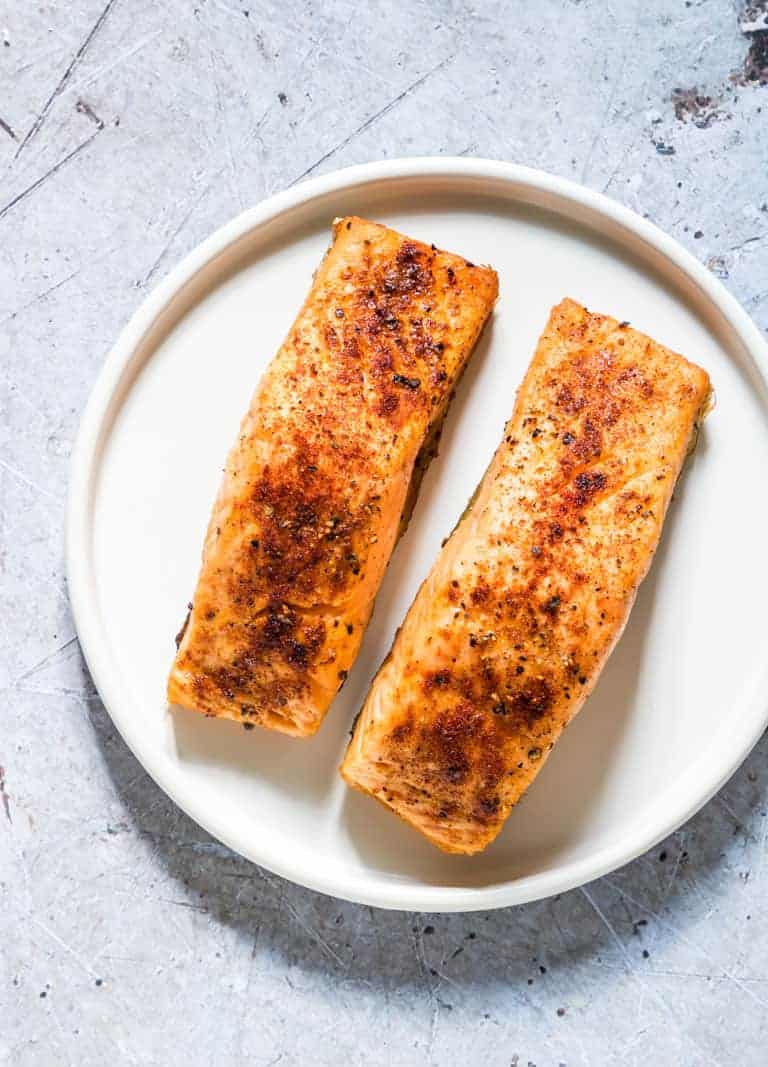 Two cooked Air Fryer Salmon fillets on a plate