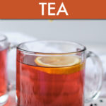 A GLASS MUG OF ELDERBERRY TEA WITH LEMON