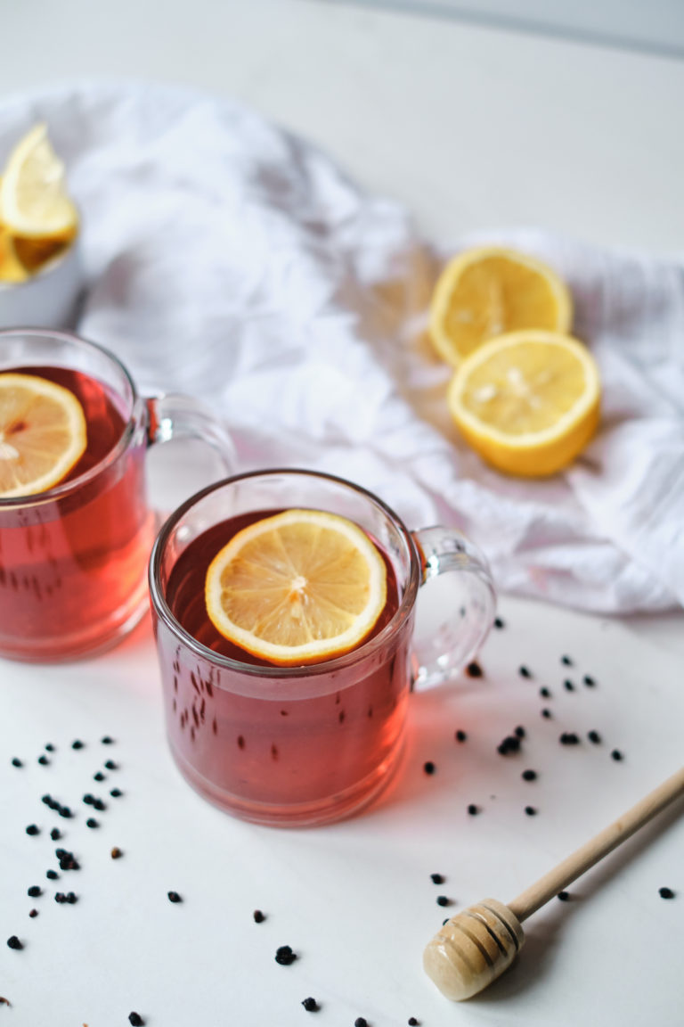 two servings of elderberry tea with slices of lemon