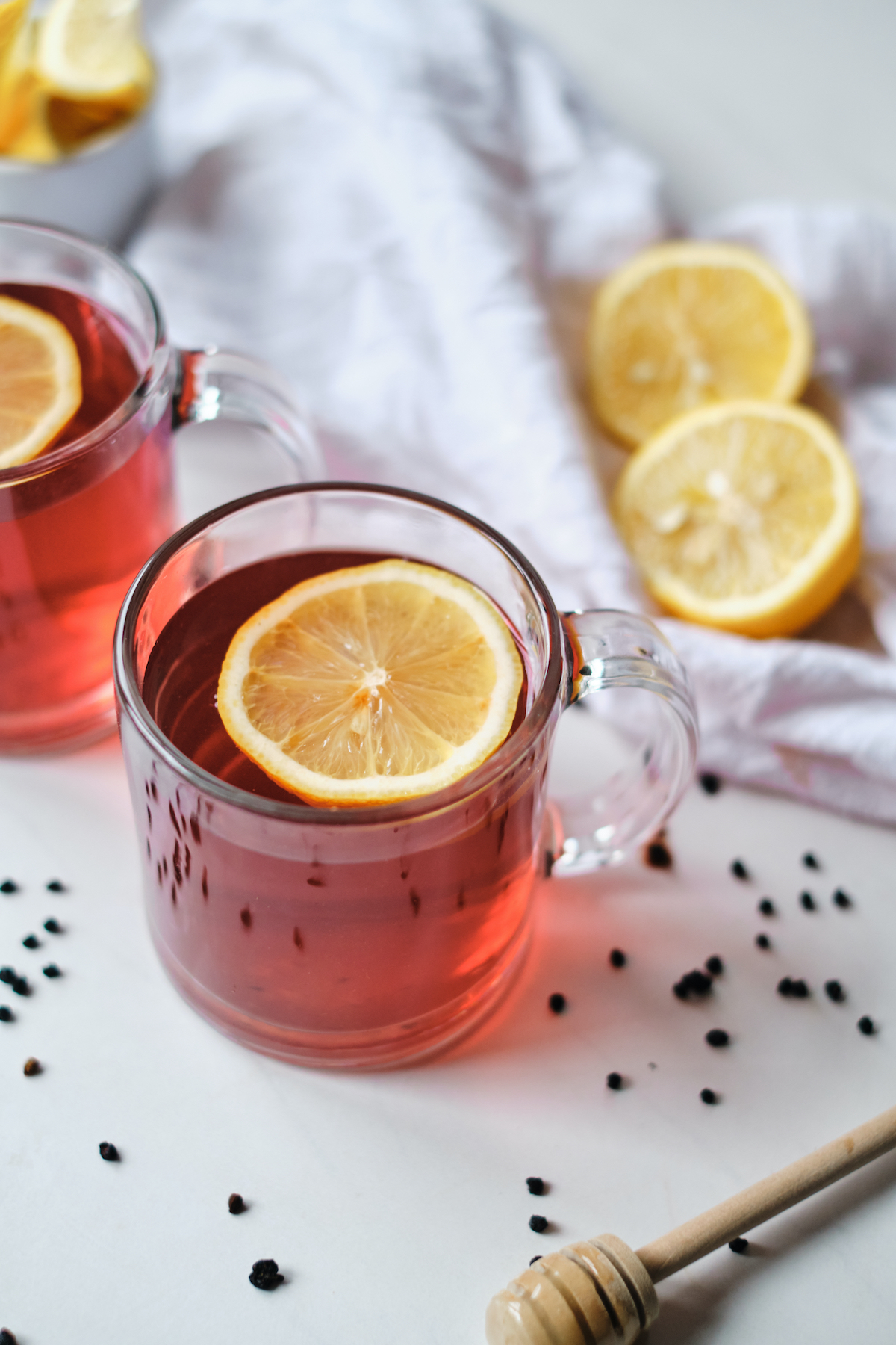 two cups of elderberry tea with lemon slices