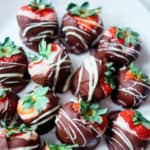 top down view of the finished chocolate coated strawberries served on a white plate