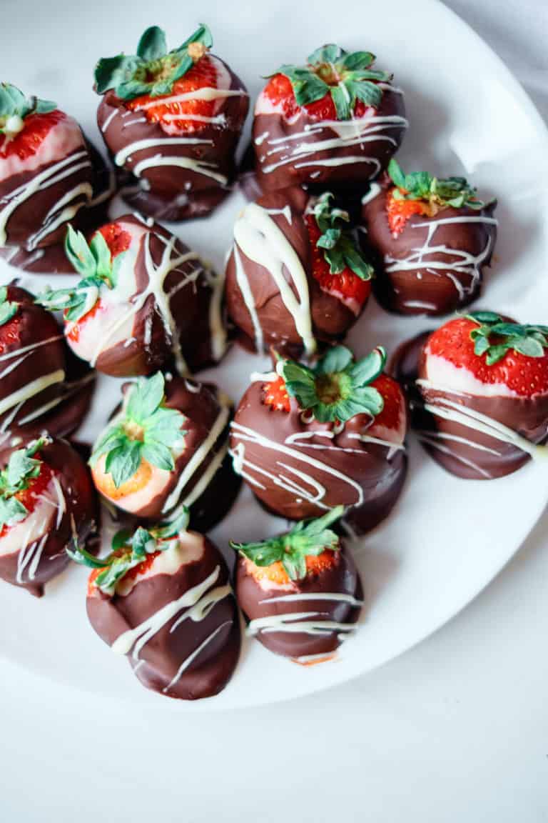 the completed instant pot chocolate covered strawberries on a white plate