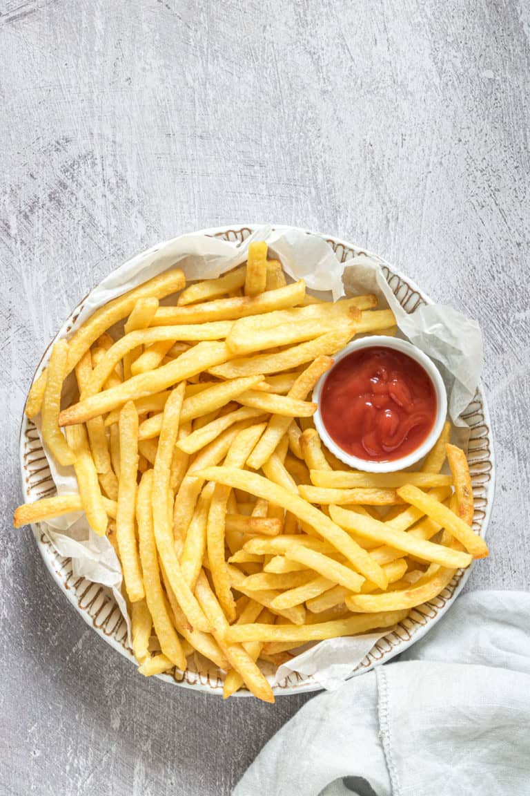 a plate filled with cooked air fryer frozen french fries