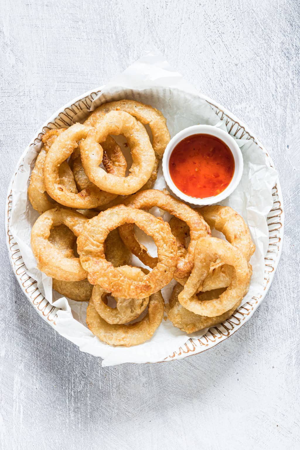 top down view of a plate filled with air fryer frozen onion rings