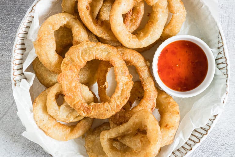 the finished air fryer frozen onion rings served on a plate