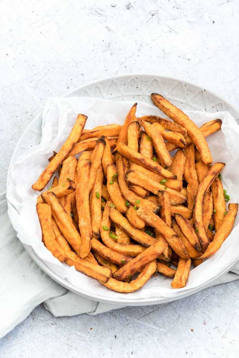 close up view of Air Fryer Sweet Potatoes served on a white plate