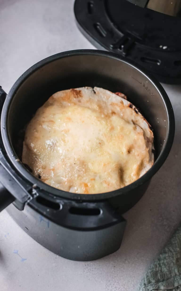 the cooked taco pie inside the air fryer basket and ready to be served