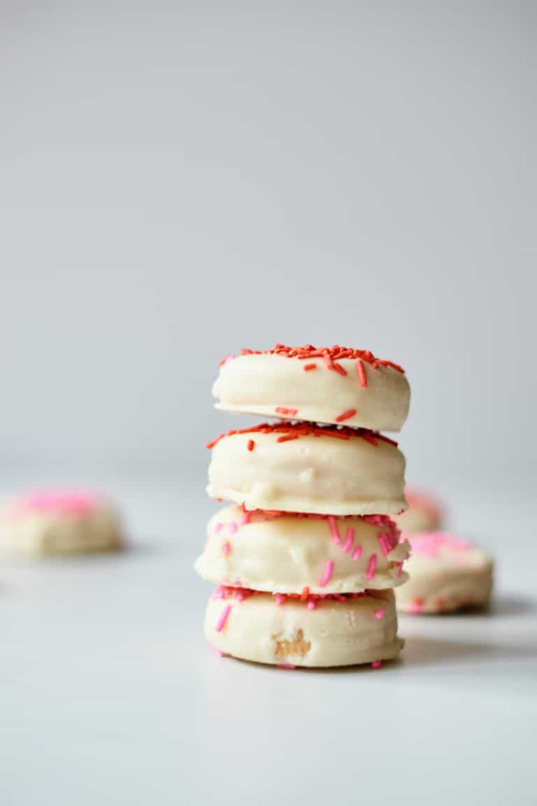 four white chocolate covered oreos stacked on top of one another