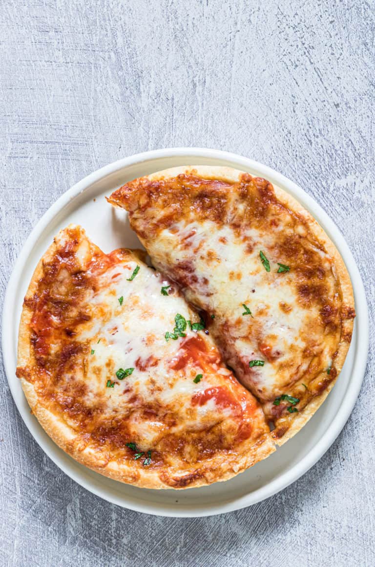 a frozen pizza that has been cooked in an air fryer ready to serve