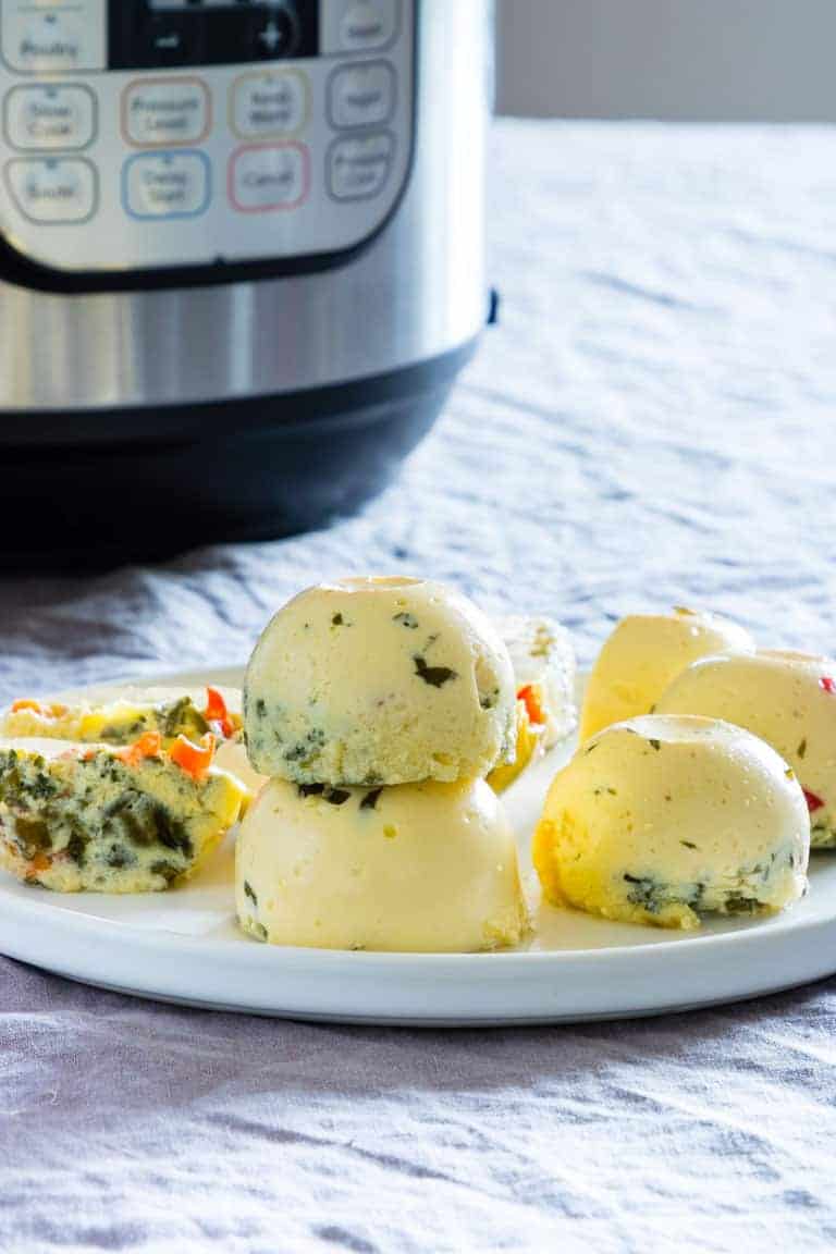 The completed Sous Vide Egg Bites Instant Pot Recipe in front of the Instant Pot