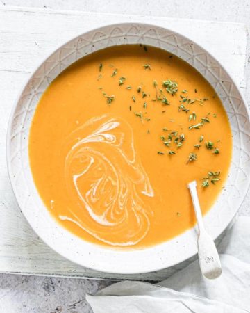 close up view of Jamaican Pumpkin Soup served with a spoon