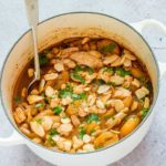 spiced turkey stew in a pot garnished with almonds