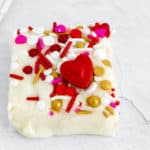 one square of white chocolate fudge decorated with Valentine's sprinkles