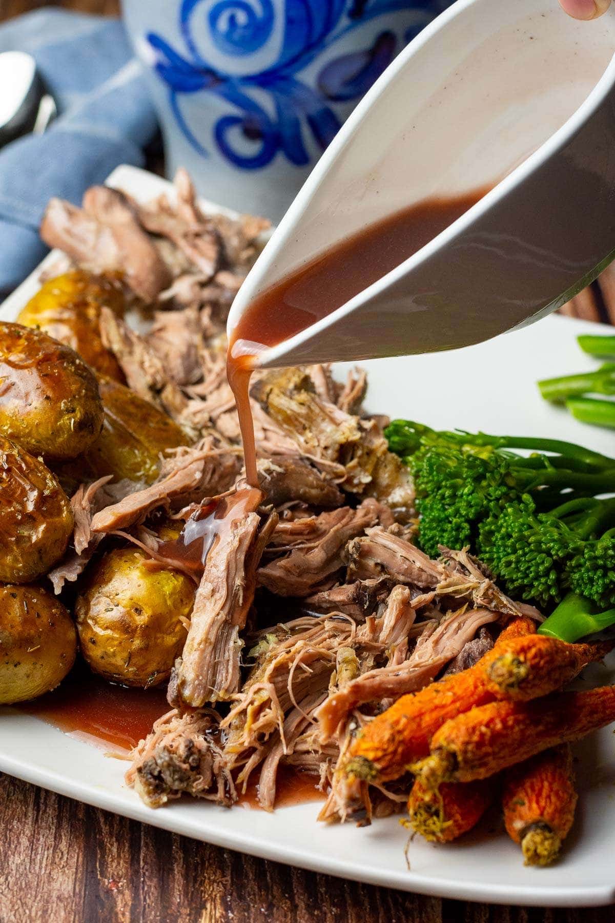 slow cooker lamb shoulder served with red wine sauce