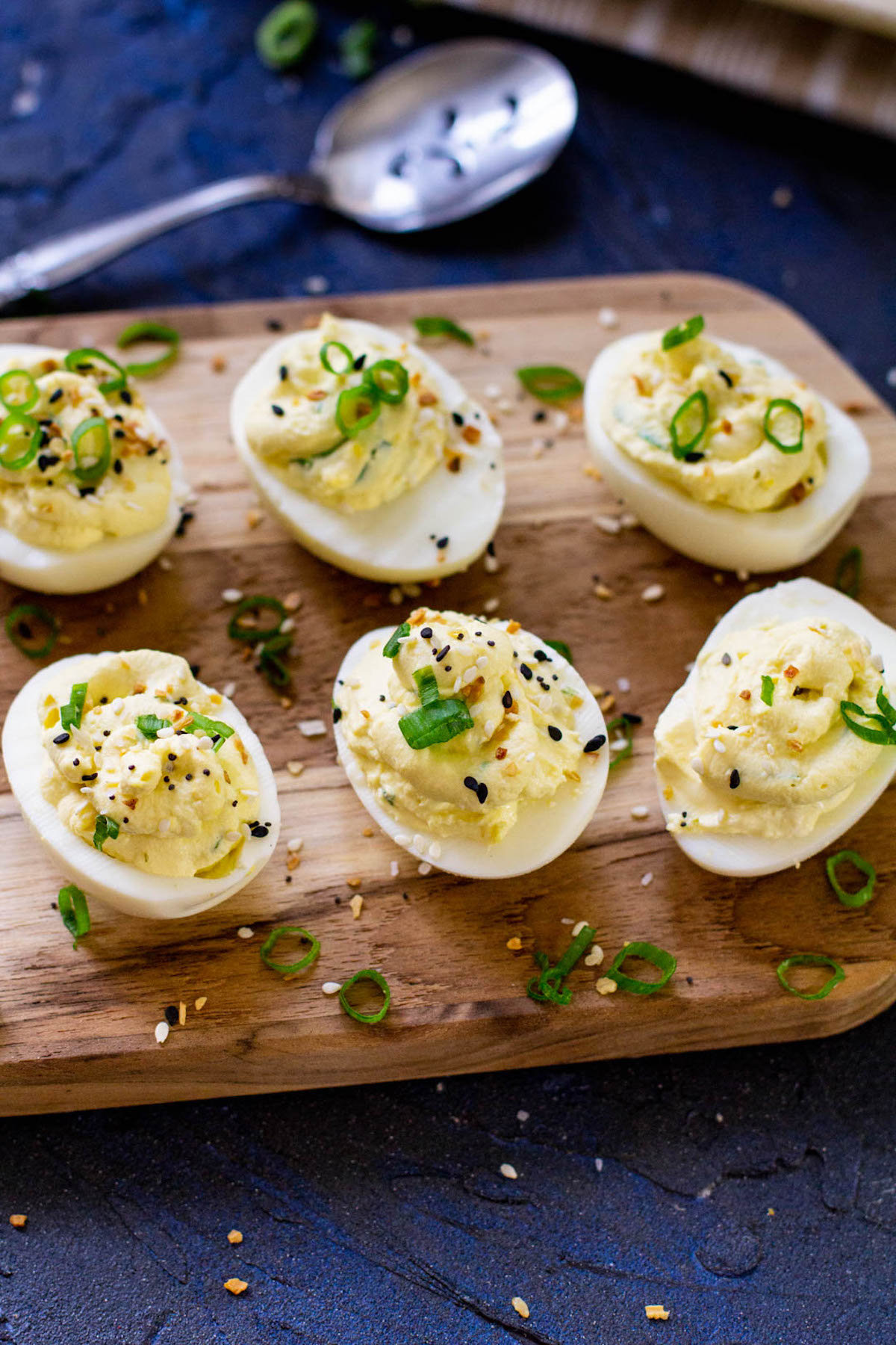 the completed instant pot deviled eggs on a wooden serving board