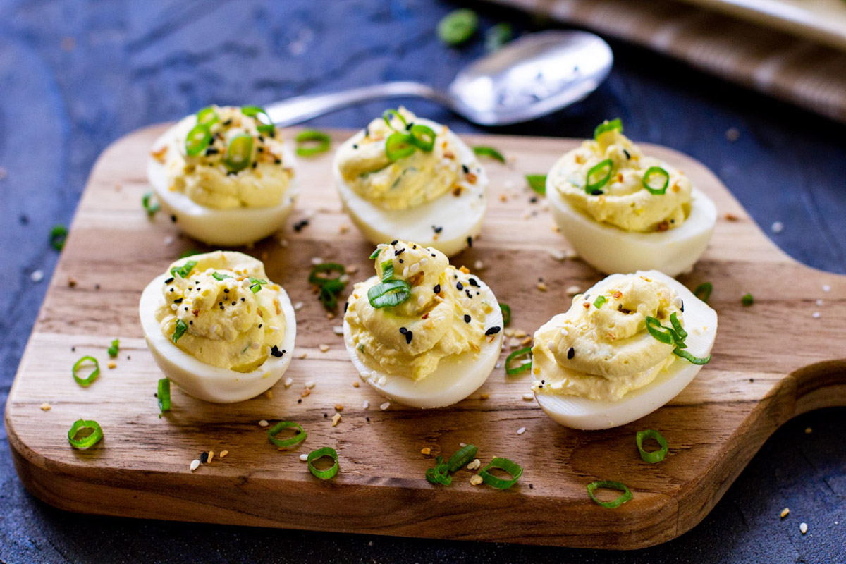 six instant pot deviled eggs on a serving board