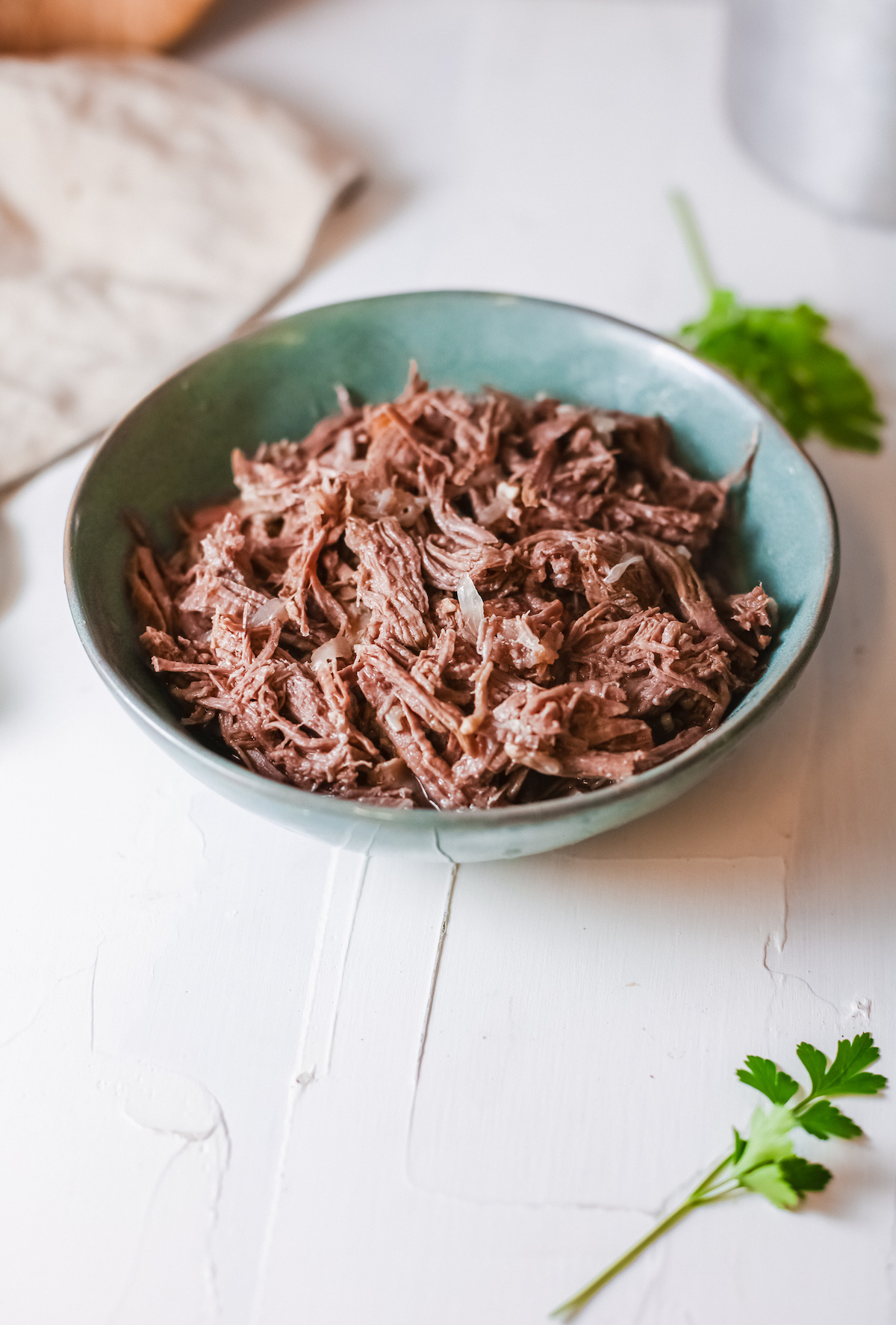 a bowl filled with the instant pot barbacoa beef