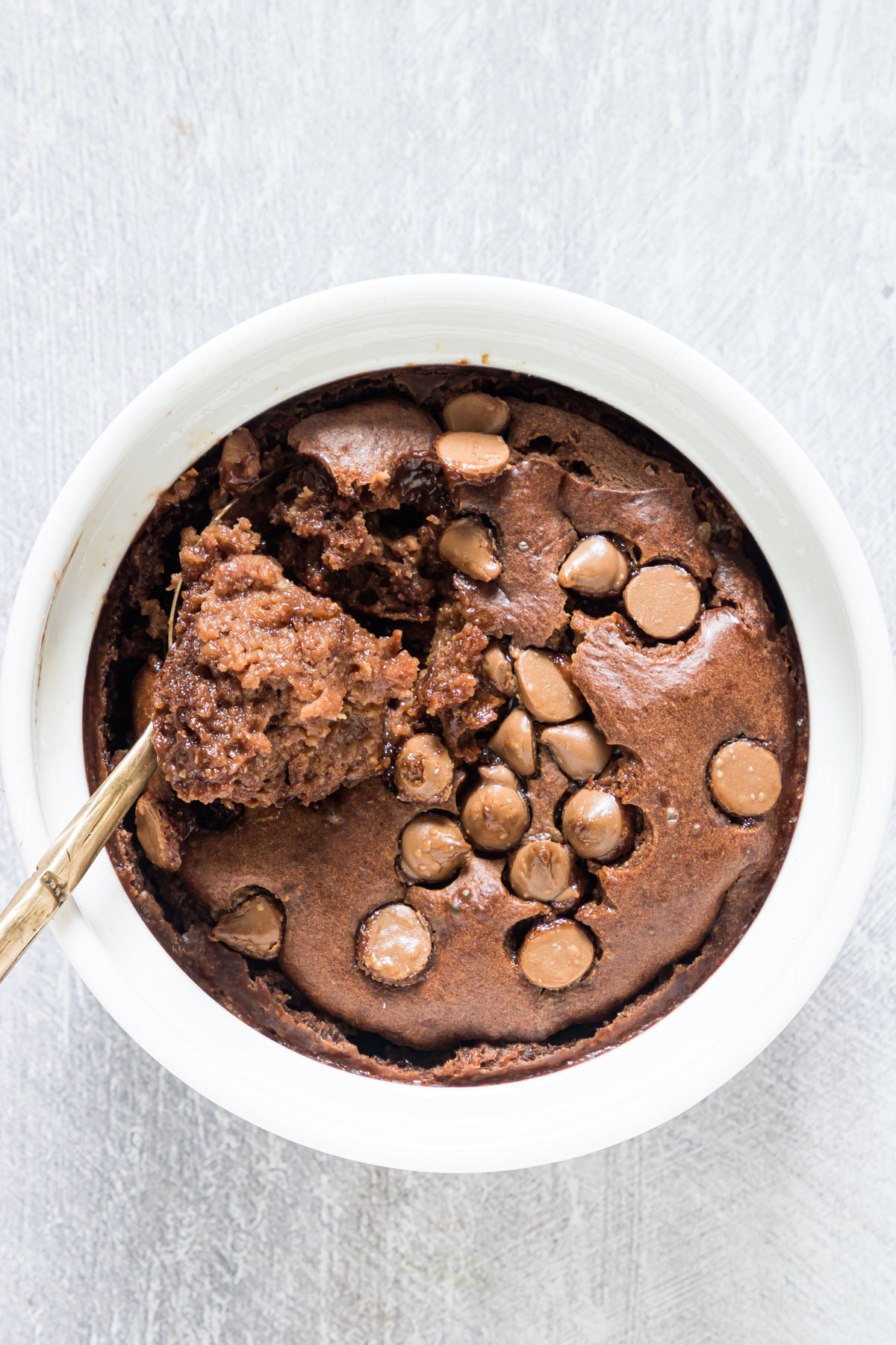 a spoon removing one bite of chocolate baked oats
