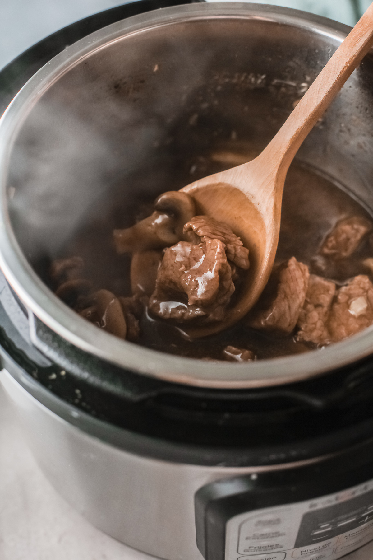 the finished instant pot beef tips and gravy inside the instant pot