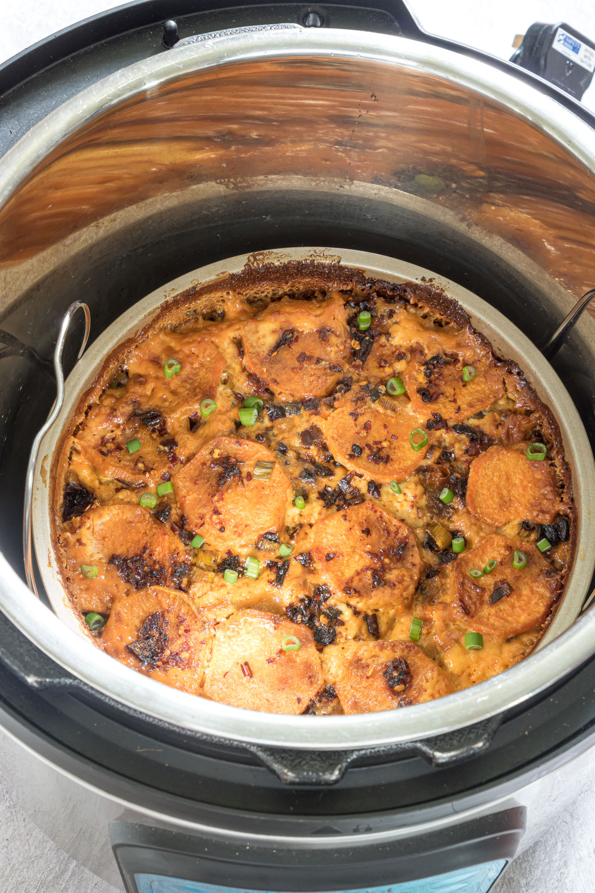Cooked Sweet Potato Gratin In a baking pan in an Instant Pot