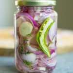a jar of pickled onions with the lid on