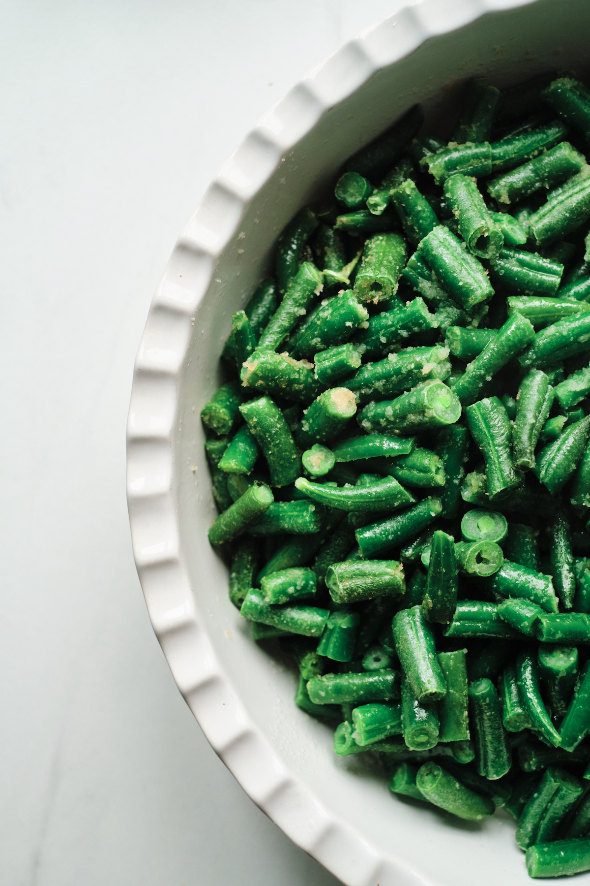 close up view of the completed air frozen vegetables recipe green beans served on a white plate