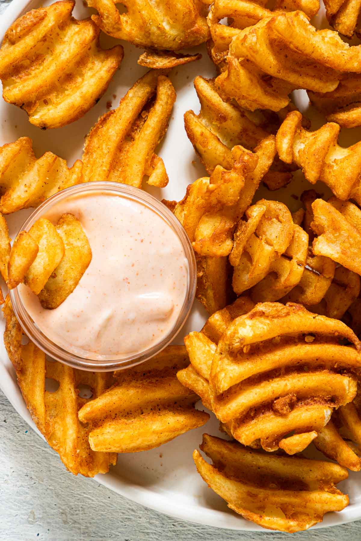 close up view of the sriracha aioli served with waffle fries