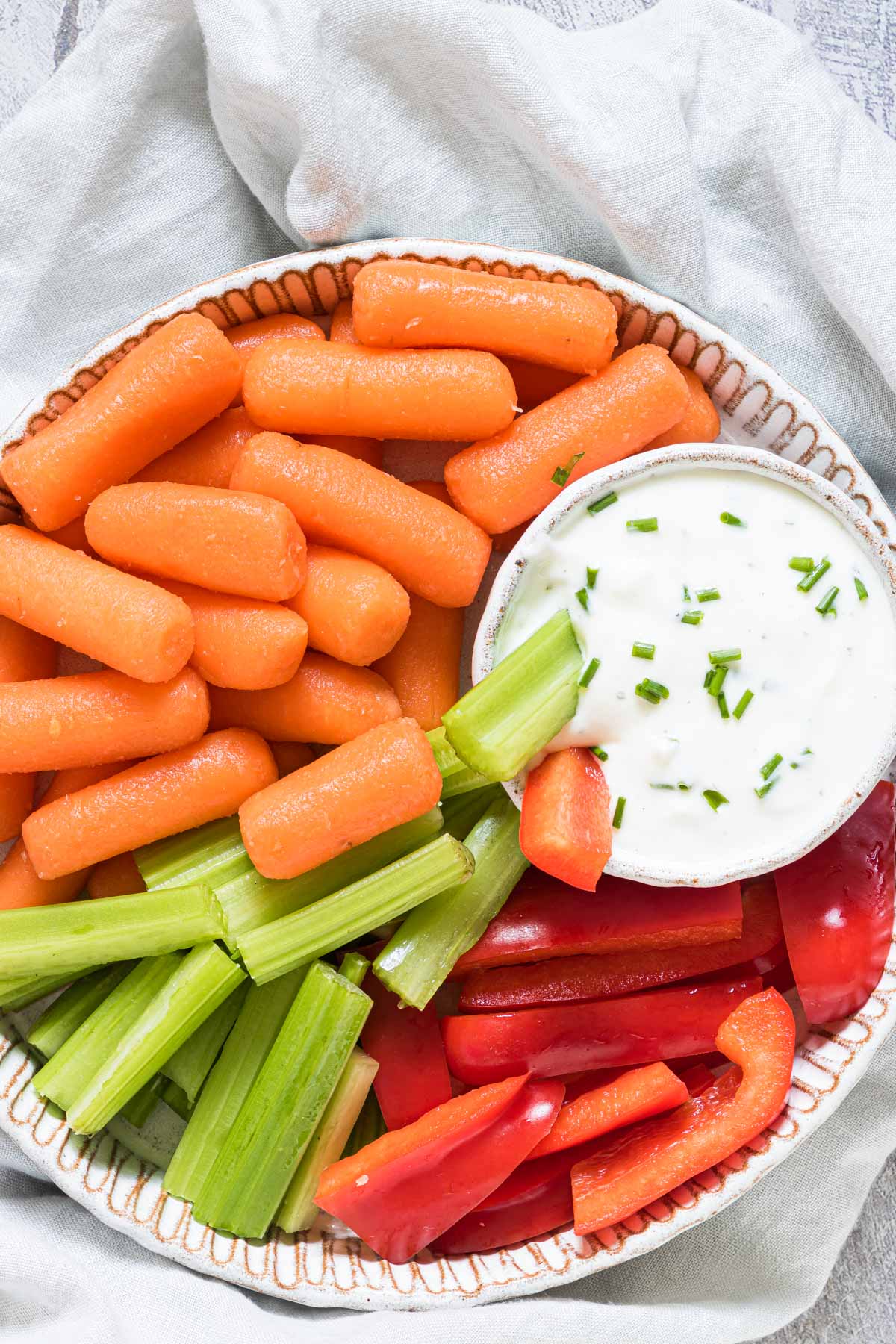 top down view of the finished greek yogurt dip with a plate of vegetables