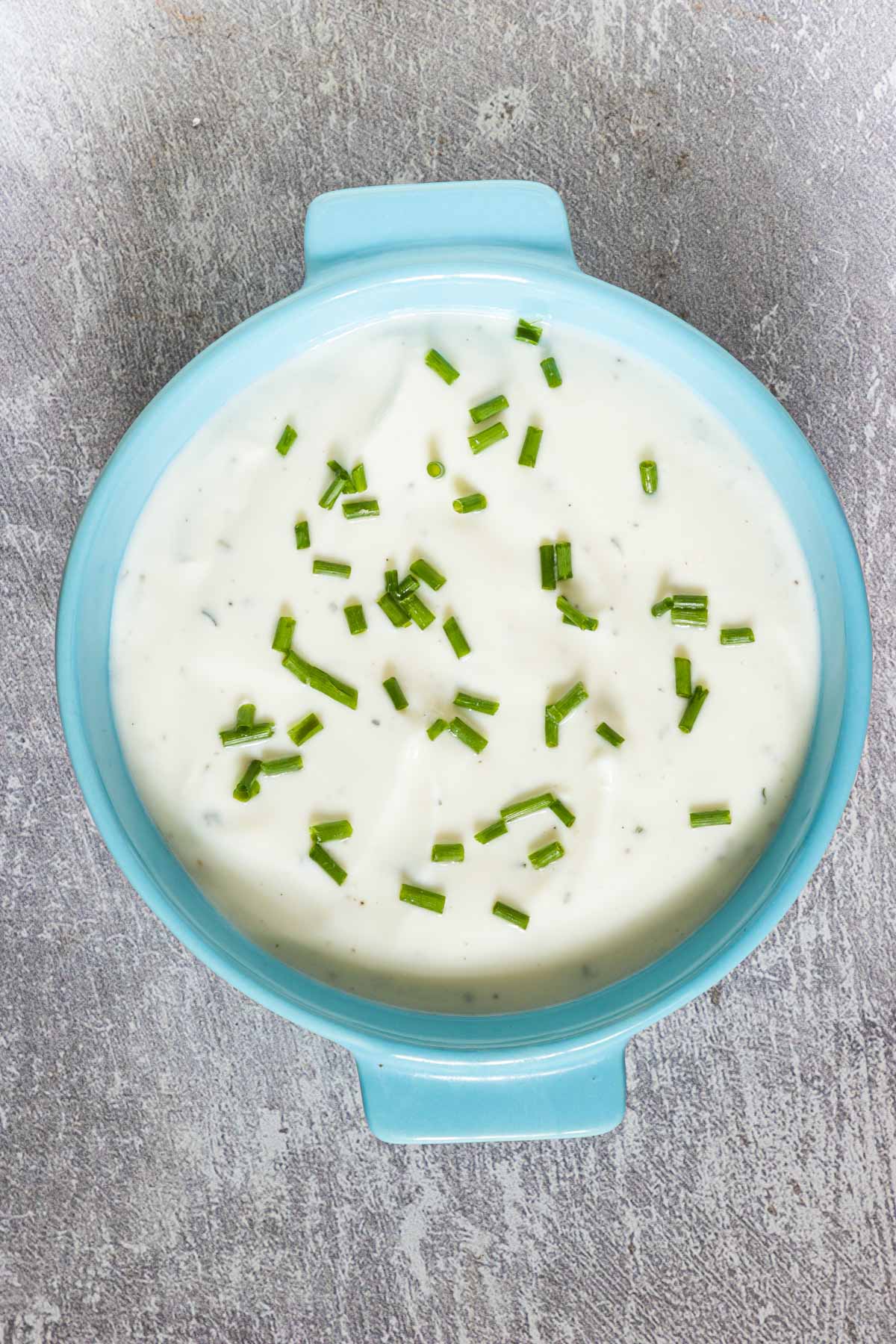 a blue bowl filled with the finished yogurt dip recipe