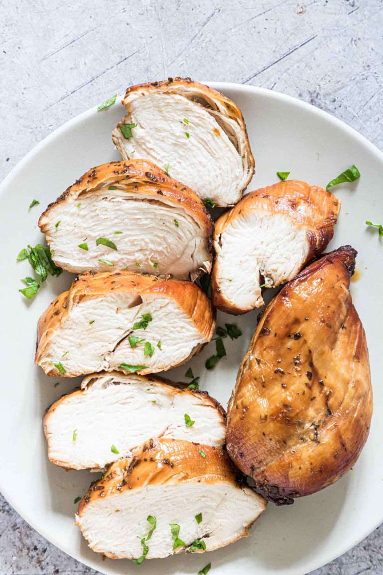 top down view of the cooked air fryer frozen chicken breast sliced and served on a white plate