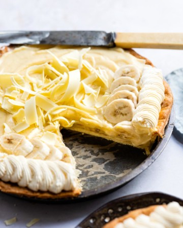 the finished banana cream pie with one slice removed