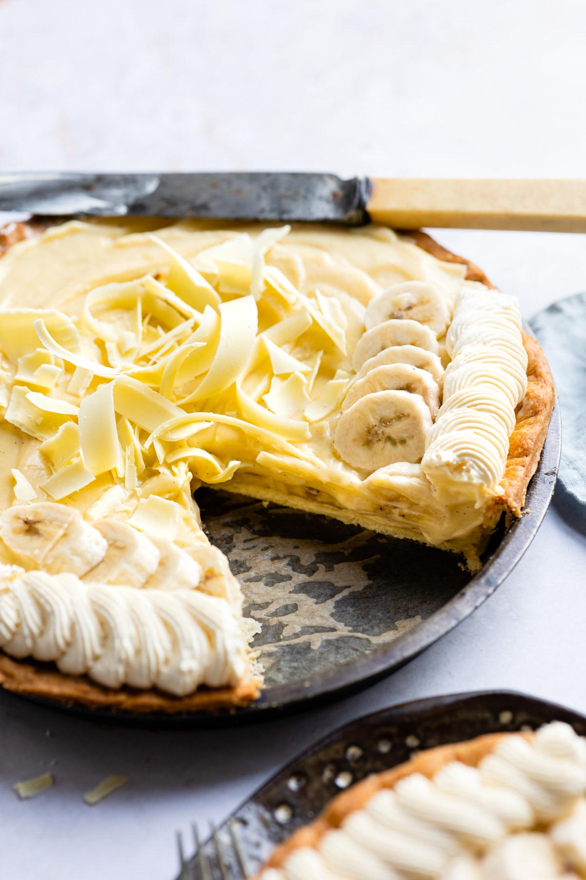 the finished banana cream pie with one slice removed