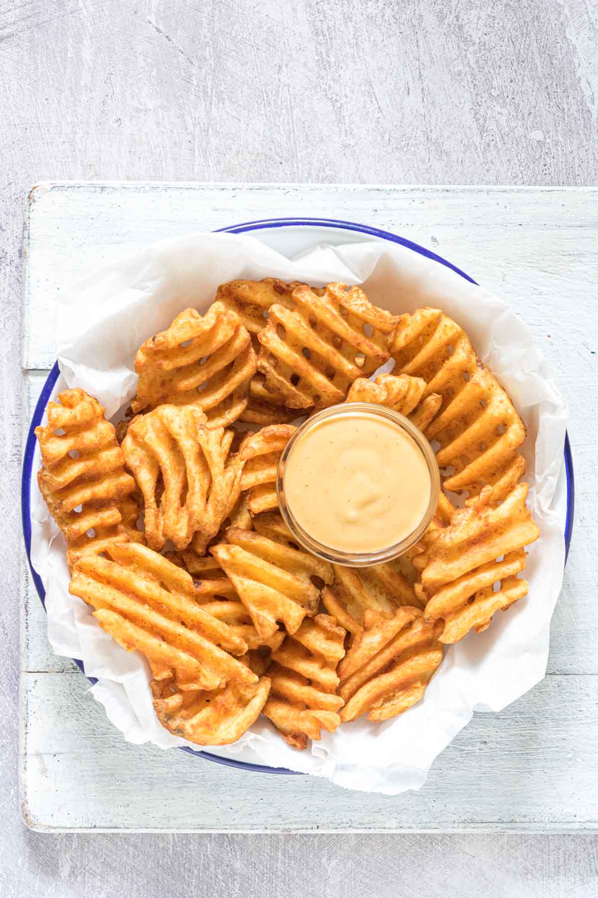 top down view of waffle fries served with homemade chick fil a sauce