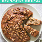 a round banana bread with slices removed on a plate