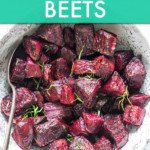 chopped, roasted beets in a ceramic bowl with a spoon