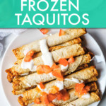 taquitos on a plate topped with tomatoes and cream