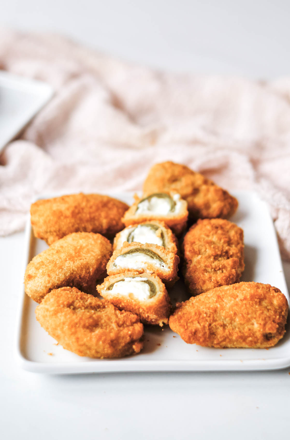 the cooked air fryer jalapeno poppers served on a white plate