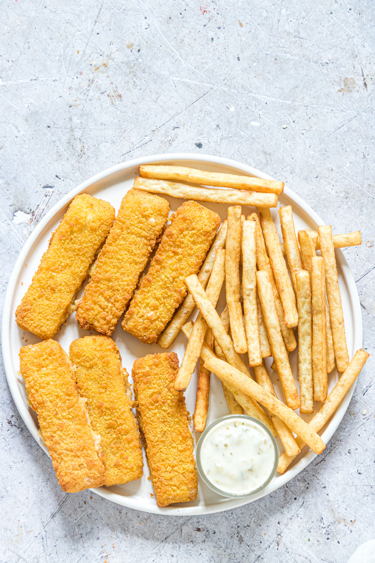 top down view of a serving of air fryer frozen fish sticks and french fries