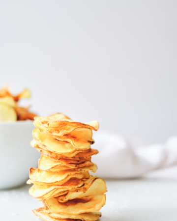 the finished air fryer potato chips stacked and ready to serve