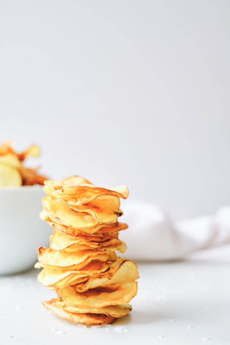the finished air fryer potato chips stacked and ready to serve
