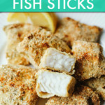 CLOSE UP OF FISH STICKS ON A PLATE WITH A WEDGE OF LEMON ON THE SIDE