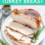 SLICED TURKEY BREAST ON A PLATE WITH ROSEMARY SPRIGS