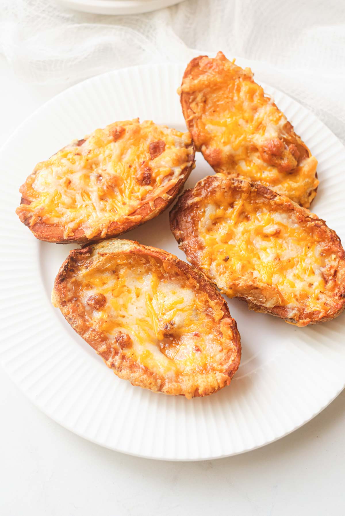 a white plate containing the frozen potato skins air fryer recipe