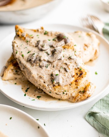 one serving of Instant Pot Chicken and Mushrooms on a white plate