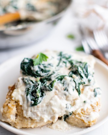 one portion of chicken florentine on a white plate