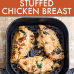 three chicken breasts in an air fryer basket