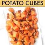 Overhead view of sweet potato cubes and pecans on a plate